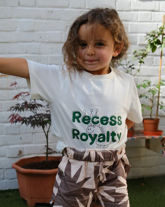 Kid in a white Mumzers Recess Royalty tee